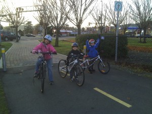 Kids posing triumphantly with their bikes